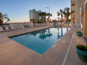 a large swimming pool with chairs and a building at Grande Caribbean 326 in Orange Beach