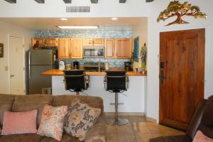 a living room with a couch and a kitchen at Tucson Home with BBQ and Patio, 5 Mi to A Mountain! in Tucson