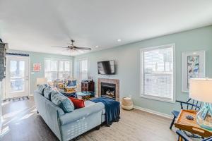 a living room with a couch and a fireplace at Carolina Daze in Topsail Beach