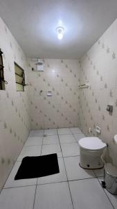 a bathroom with a toilet and a sink at Pousada Central Jaraguá in Jaraguá do Sul