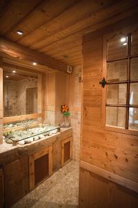a large bathroom with a sink and a window at Logis hôtel Arbez Franco Suisse in Les Rousses
