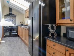 a kitchen with a large stainless steel refrigerator at West Lanegate Farmhouse in Amisfield Town