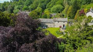 an old house in the middle of a forest at Carrholme Cottage in Settle