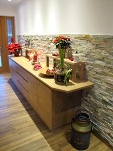 a kitchen with a counter with flowers in a vase at Haus am Mühlbach in Weissensee