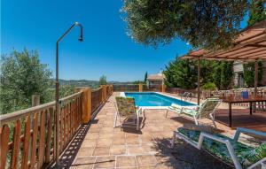 a patio with a table and chairs and a pool at Stunning Home In Montefrio With Kitchen in Montefrío