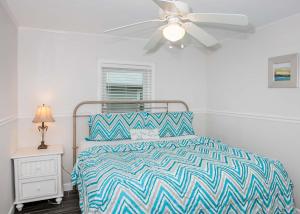 a bedroom with a bed and a ceiling fan at Breaking Even House in Fort Morgan