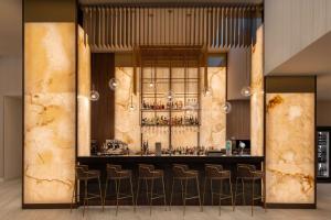 a bar in a restaurant with bar stools at Radisson Blu Hotel, Cluj in Cluj-Napoca