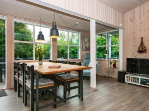 a dining room with a wooden table and chairs at 6 person holiday home in Struer-By Traum in Struer