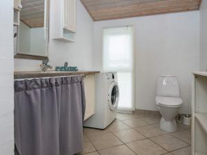 a bathroom with a washing machine and a toilet at 6 person holiday home in Struer-By Traum in Struer +51 photos