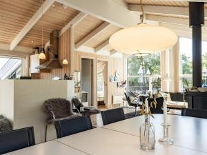a dining room and living room with a table and chairs at 8 person holiday home in Otterup in Otterup