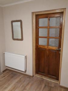 a room with a door and a radiator and a mirror at Apartment in the city center in Tbilisi City