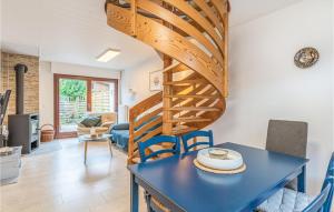 a spiral staircase in a living room with a table and chairs at 2 Bedroom Gorgeous Home In Hennstedt in Hennstedt
