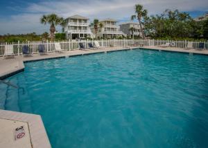 a large pool with blue water in a resort at Shiloh House in Fort Morgan