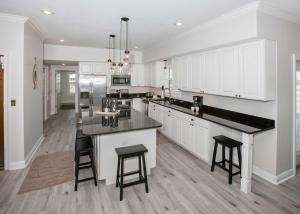 a kitchen with white cabinets and black counter tops at Shiloh House in Fort Morgan