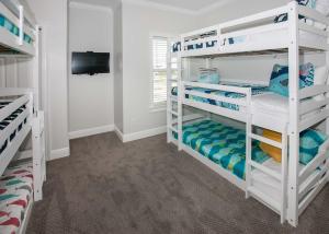 a bedroom with white bunk beds in a room at Shiloh House in Fort Morgan +42 photos