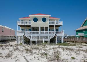 a large white house on the beach with sand at Shiloh House in Fort Morgan