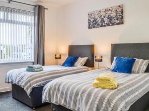 dwa łóżka siedzące obok siebie w sypialni w obiekcie The Bungalow w mieście Carnoustie