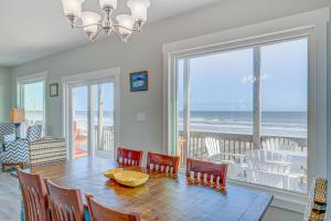 ein Esszimmer mit einem Tisch und Meerblick in der Unterkunft Avalon Topsail Beach in Topsail Beach