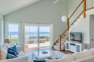 a living room with a view of the ocean at Slow Your Roll in Topsail Beach