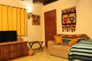 a living room with a couch and a television at Rustic Luxury Retreat Near Historic Zacatlan in Zacatlán