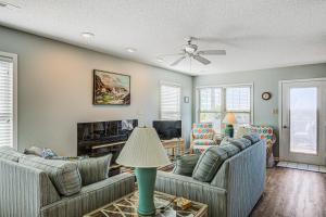 a living room with two couches and a fireplace at Baylin A in Topsail Beach