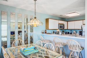 a kitchen and dining room with a table and chairs at Baylin A in Topsail Beach