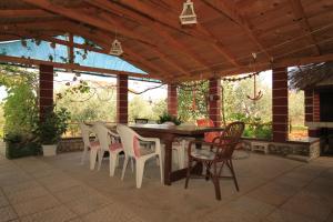 a wooden table and chairs on a patio at Apartments with parking space Ugljan - 8479 in Ugljan