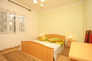een slaapkamer met een bed en een raam bij Apartments by the sea Ugljan - 8266 in Ugljan