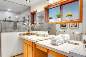 a bathroom with two sinks and a shower at Buck Mountain Home 