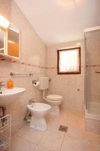 a bathroom with a toilet and a sink and a shower at Apartments by the sea Zdrelac, Pasman - 8298 in Ždrelac