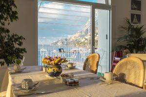 a table with a vase of flowers on top of a table at Hotel Marina Riviera in Amalfi