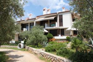 a house with a garden in front of it at Apartments with parking space Cres - 7876 in Cres