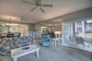 a living room with a couch and a table at Coastal Golf Resort Condo Less Than 4 Mi to Beach! in North Myrtle Beach