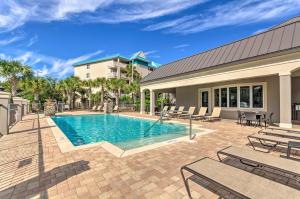 a swimming pool with patio furniture and a building at Miramar Beach Condo 5 Minute Walk to Beach! in Destin