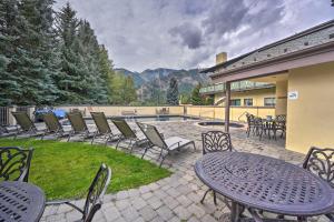 a patio with chairs and a table and a pool at Modern Ketchum Condo Walk to Dtwn and Ski Lift in Ketchum