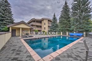 a swimming pool in front of a house at Modern Ketchum Condo Walk to Dtwn and Ski Lift in Ketchum