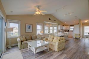 a living room with a couch and a table at Pinella Beach House in North Topsail Beach