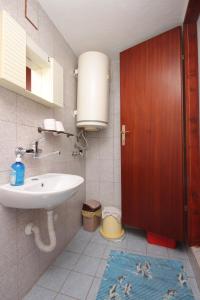 a bathroom with a sink and a mirror and a toilet at Apartment Stivan 382a in Štivan