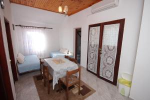 a dining room with a table and a bedroom at Apartment Stivan 382a in Štivan
