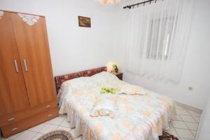 a bedroom with a bed and a wooden cabinet at Apartment Stivan 382c in Štivan
