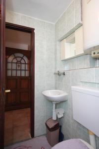 a bathroom with a sink and a toilet and a door at Apartment Stivan 382c in Štivan