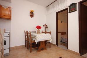 a kitchen with a table and chairs and a room at Apartment Stivan 382c in Štivan