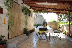 a patio with a table and chairs in a building at Apartment Stivan 382c in Štivan