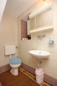 a bathroom with a toilet and a sink at Apartment Stivan 382d in Štivan