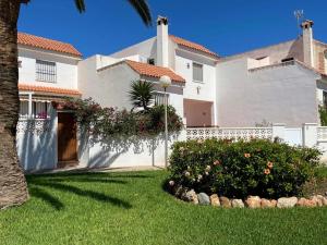 a large white house with a yard with a tree at Modern holiday home in Roquetas de Mar with private terrace in Roquetas de Mar