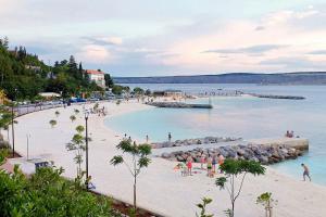 a group of people on a beach in the water at Apartments with parking space Smrika, Kraljevica - 15709 in Šmrika