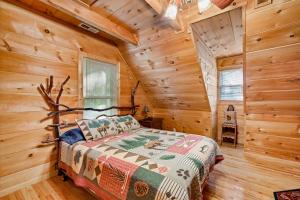 a bedroom with a bed in a log cabin at Rustic Retreat in West Jefferson