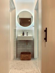 a bathroom with a sink and a mirror at THE DAVEY Luxury home in Nambucca Heads