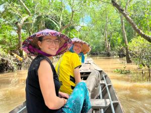 two people riding on the back of an elephant at Sao Mai Hotel in Cai Be