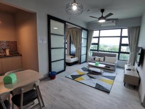 a living room with a couch and a table at Jesselton Quay Citypads in Kota Kinabalu